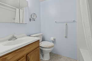 Full bathroom featuring vanity, light tile patterned flooring, and shower / bath combo
