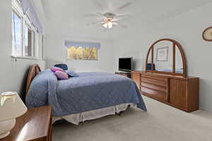 Bedroom with carpet floors and a ceiling fan