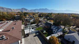 Aerial view of property's location with a mountain backdrop and nearby suburban area