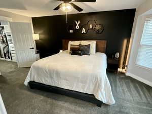 Bedroom featuring dark colored carpet and a ceiling fan
