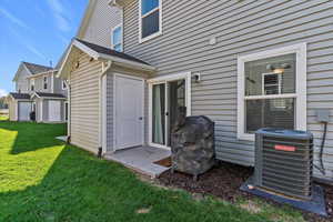 Doorway to property featuring a lawn