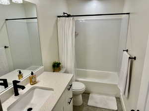 Bathroom featuring shower / bath combination with curtain and vanity