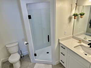 Bathroom with vanity and a stall shower