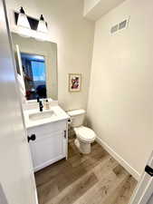 Bathroom with vanity, light wood-type flooring, and ensuite bathroom