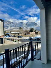 Snow covered back of property featuring a mountain view