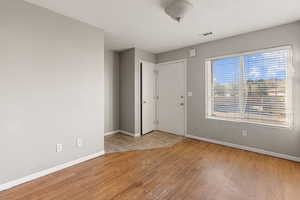 Foyer featuring light wood-style flooring and a textured ceiling