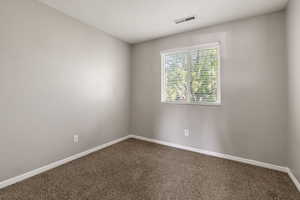 Unfurnished bedroom featuring carpet and baseboards
