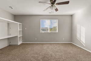 Family room with carpet floors, a textured ceiling, and a ceiling fan