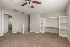 Carpeted family room room featuring a ceiling fan and a textured ceiling