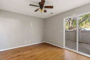 Primary bedroom featuring light wood finished floors and ceiling fan