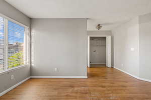 Living room with light wood-type flooring, a textured ceiling, and a ceiling fan