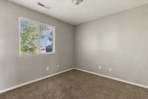 Carpeted bedroom with baseboards