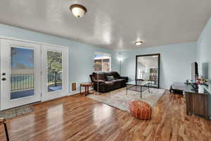 Living room with a textured ceiling and light wood finished floors