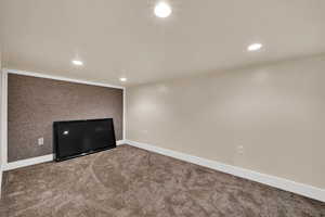 Carpeted spare room with baseboards and recessed lighting