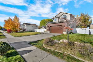 Traditional-style house with brick siding, driveway, and a garage