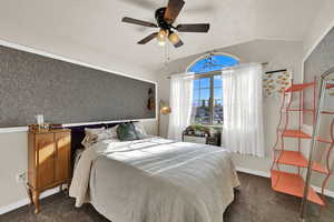 Bedroom featuring lofted ceiling, dark colored carpet, ceiling fan, wallpapered walls, and a textured ceiling