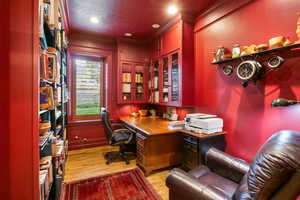 Office featuring light wood-type flooring, a textured ceiling, crown molding, and recessed lighting