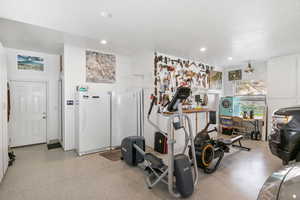 Exercise room with a textured ceiling and recessed lighting