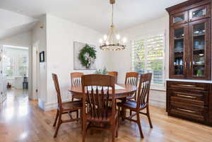 Dining room featuring light wood finished floors and a chandelier