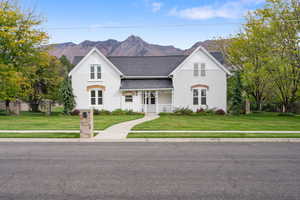 View of front of home featuring covered porch, a mountain view, and stucco siding