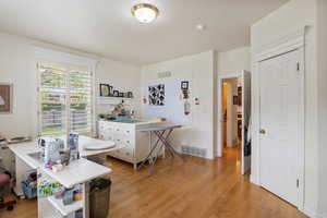 Office space with light wood-style floors and a textured ceiling