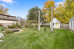 Fenced backyard with an outbuilding
