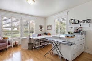 Office space with light wood-style flooring and a textured ceiling