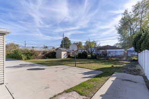 Fenced backyard with a patio and an outdoor structure