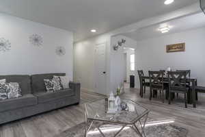 Living area with wood finished floors and recessed lighting