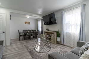 Living room with light wood-style flooring