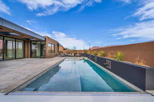 View of pool with a patio, a pool with connected hot tub, and a fenced backyard