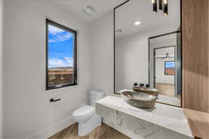Half bathroom with vanity, wood finished floors, a ceiling fan, and recessed lighting