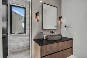 Bathroom with tile walls and vanity