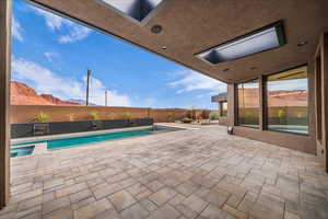 View of pool with a patio area and a fenced backyard