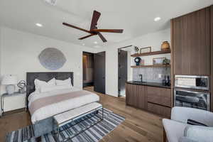 Bedroom with light wood-style flooring, a ceiling fan, wine cooler, and recessed lighting