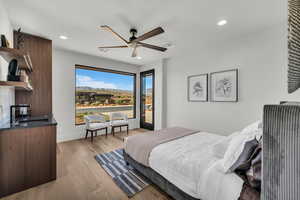 Bedroom with access to exterior, light wood-style floors, ceiling fan, and recessed lighting