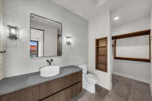 Bathroom featuring vanity, recessed lighting, and built in features
