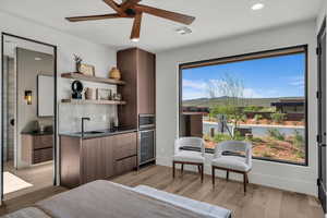 Bedroom with recessed lighting, wine cooler, ceiling fan, and light wood finished floors