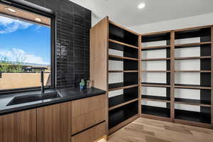 Walk in closet featuring light wood-style flooring and a sink