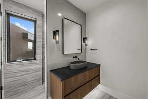 Full bathroom featuring vanity and baseboards