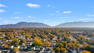 View of mountain backdrop featuring nearby suburban area