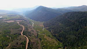 View of mountain backdrop featuring a heavily wooded area