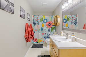 Full bath featuring vanity and a shower with shower curtain