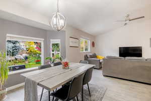 Dining room with vaulted ceiling and light wood-type flooring