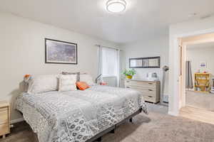 Bedroom featuring carpet and a textured ceiling