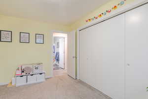 Playroom featuring light colored carpet and baseboards