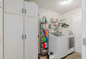 Laundry room featuring a textured ceiling and washer and dryer