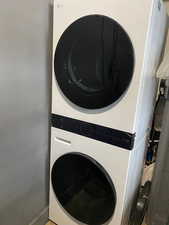 Laundry room featuring stacked washer / drying machine