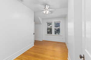 Additional living space featuring light wood-style flooring and ceiling fan