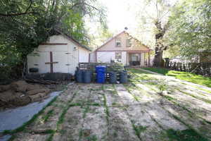 Rear view of property featuring a storage shed and a patio